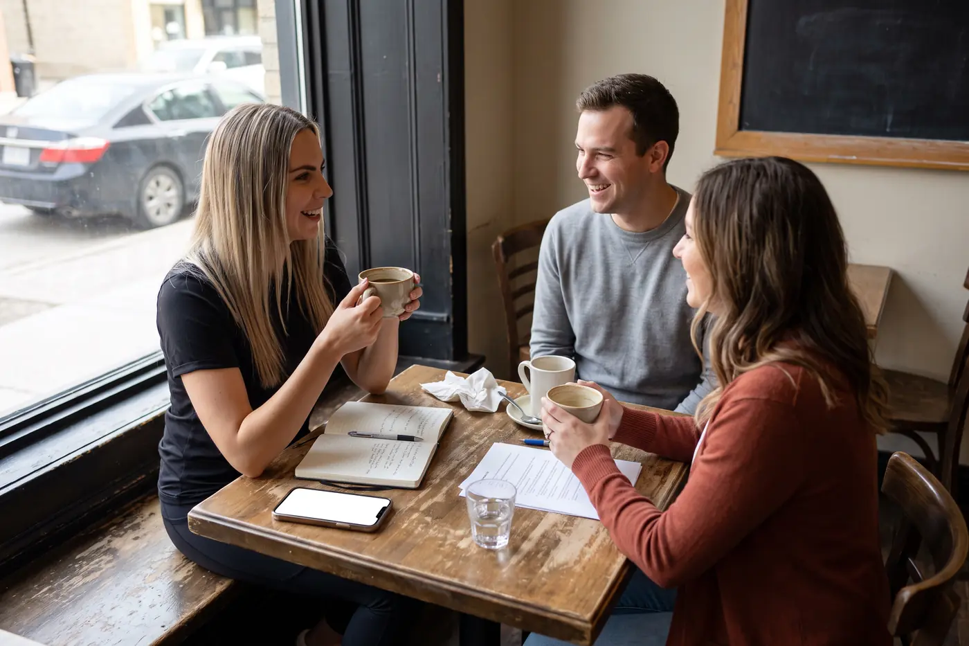 Adela meeting clients at a café